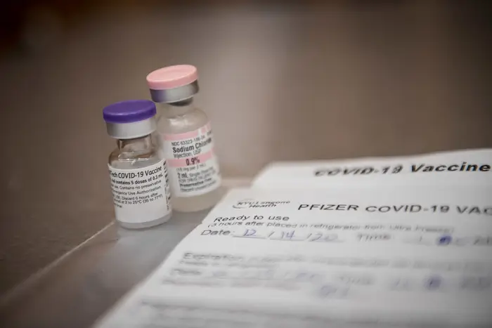 A close up of two vials of of the Pfizer vaccine
